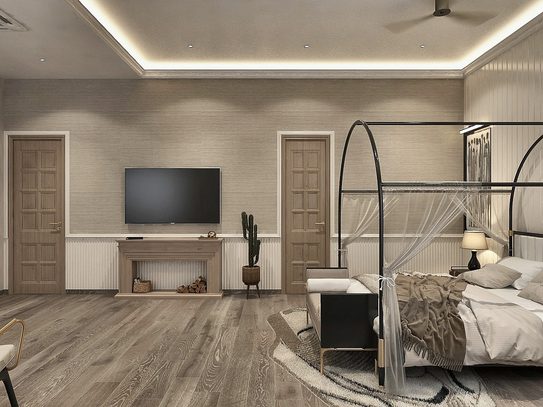 The same bedroom from the other side — a low panelled wall carrying a television, the arched canopy bed to the right.